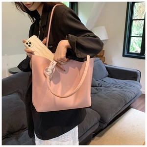 Detail of pink large capacity leather tote bag with silk scarf and FASHION logo