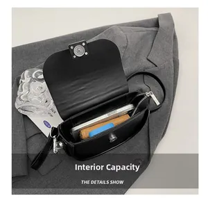 Detail showing the internal capacity of the black saddle bag with silver magnetic closure