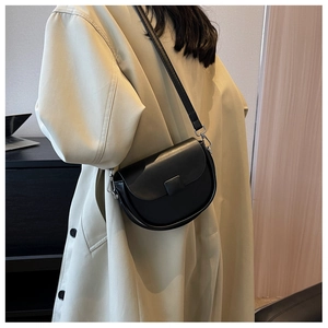 Classic black saddle bag showing soft leather texture and silver buckle detail