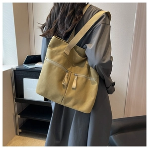 Close-up of mustard yellow canvas tote bag with functional front zipper pockets for women