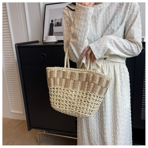 Detailed macro view of woven straw beach bag featuring intricate mesh hollow pattern