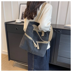 Detail view of large canvas tote bag with khaki straps and zipper pockets for women