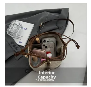 Top macro view of woven straw bucket bag interior showing spacious capacity and storage