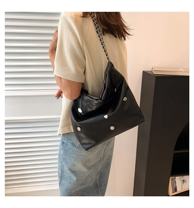 Detail of black large capacity hobo bag with silver heart studs and chain strap