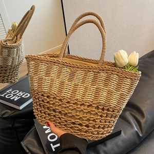 Handmade woven straw tote bag with hollow mesh design and top handles for summer beach