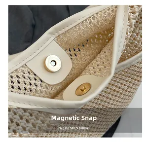 Detail of golden magnetic snap on beige woven straw bag with leather reinforcement