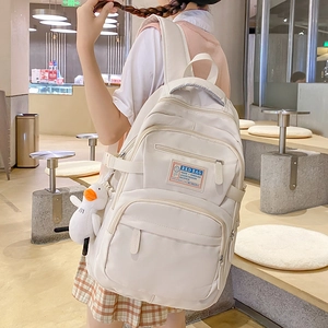 Off-white multi-pocket nylon backpack for women with cute duck pendant for casual travel
