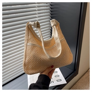 Detail of light beige woven tote bag with hollow mesh texture and PU shoulder strap