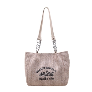 Beige woven straw tote bag with black embroidery and silver chain leather strap