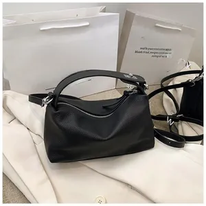 Détail du cuir grainé noir et de la poignée sur un grand sac Boston élégant