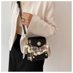 Detail of checkered tweed crossbody bag with pearl flower buckle and silk scarf chain