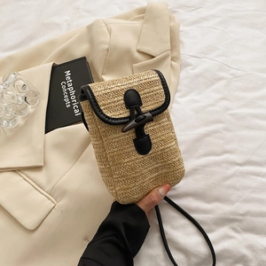Minimalist straw woven square crossbody bag with black leather trim and toggle button