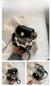 Detail of tweed crossbody bag with pearl embellishment and silk scarf handle decoration