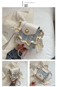 Detail of light blue tweed crossbody bag with pearl flower buckle and silk scarf strap