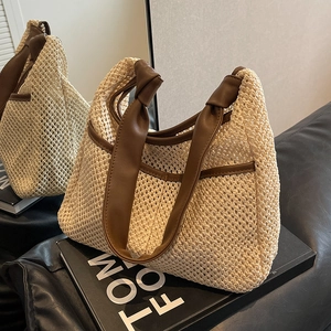 Bohemian hand-woven straw tote bag with brown faux leather trim and knotted straps