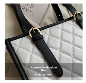 Detail showing the adjustable shoulder strap and black trim on a white quilted tote bag