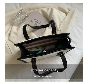 Macro view of the large capacity interior of a quilted tote bag showing daily essentials