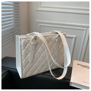 Close-up of white quilted tote bag with golden hardware and premium PU leather texture