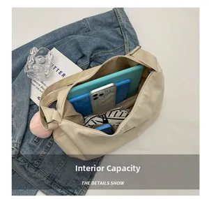 Detail view of spacious interior storage for tablets and essentials in nylon hobo bag