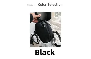 Detail of small black crossbody phone bag with nylon strap and top handle