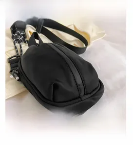 Detail of waterproof crossbody bag with textured strap and matte zip closure