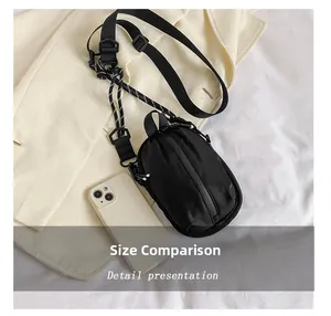 Nylon crossbody phone bag with adjustable strap shown with phone for size comparison