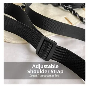 Detail view of the black nylon adjustable shoulder strap with matte plastic buckle