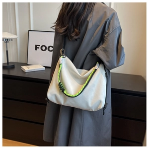 Detail of the high-density nylon crescent bag with fluorescent green braided rope handle