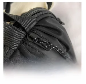 Detailed close-up of the smooth black zipper with a Newfashion brand woven puller