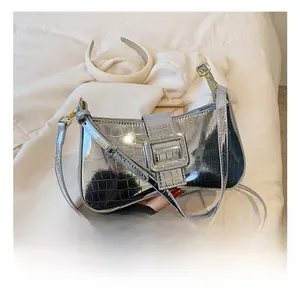 Detail of silver crocodile pattern leather underarm bag with decorative metal buckle
