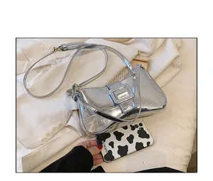 Detailed close-up of silver crocodile embossed baguette bag with magnetic buckle closure