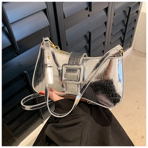 Detail of silver crocodile pattern shoulder bag with metallic finish and large square buckle