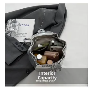 Internal capacity of silver star bucket bag showing phone, wallet and cosmetics