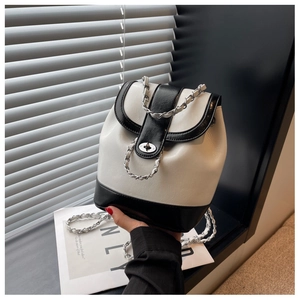 Detail of contrast stitching and silver metal swivel lock on the bicolor backpack