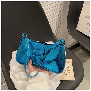 Close-up of metallic blue crocodile embossed underarm bag with large silver buckle