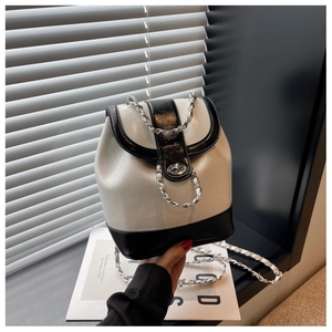 Detail of contrast bucket backpack with metal chain strap and silver twist lock closure