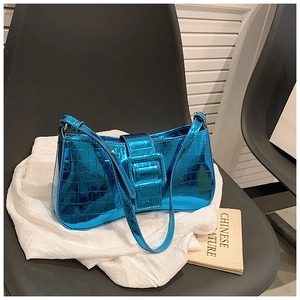 Close-up of metallic blue crocodile pattern underarm bag with decorative buckle