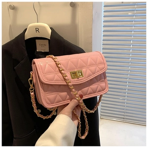 Gros plan détaillé du sac matelassé rose avec fermoir doré et bandoulière en chaîne