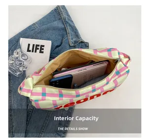 Detailed internal capacity of the yellow plaid canvas crossbody bag with zipper pockets