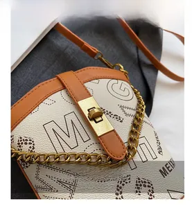 Detail of vintage cream bucket bag with leopard print and golden twist-lock closure