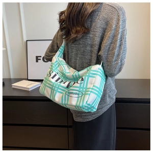 Green checkered canvas shoulder bag with Simple print shown on model from back view
