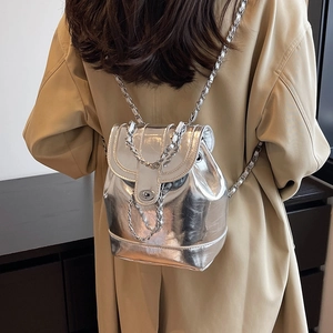 Silver metallic chain backpack for women featuring a glossy finish and turn-lock closure