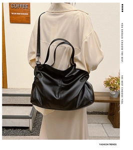 Black large capacity tote bag in lychee texture leather with dual handles and slim strap