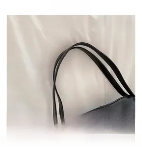 Macro detail of high-quality lychee textured leather handle with reinforced black stitching