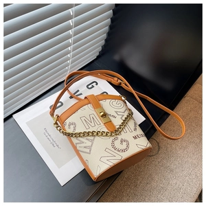 Detail of beige bucket bag with metal twist lock, letter print and gold chain strap