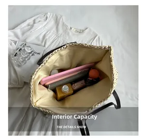 Macro view of the large capacity straw bag interior showing zipper and fabric lining
