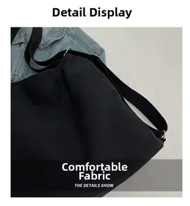 Detail showing the comfortable cotton canvas fabric and adjustable strap of the black bag