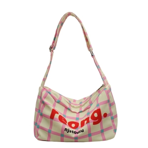 Pink and green plaid canvas crossbody pillow bag with adjustable wide shoulder strap
