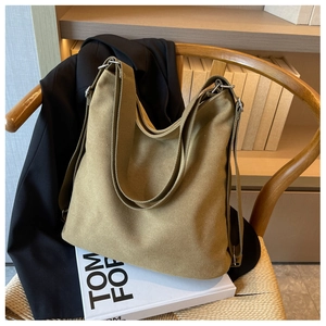 Detail of khaki canvas tote bag with thick texture on a wooden chair for commuting