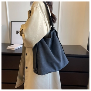 Detail of adjustable metal strap buckle on a black canvas tote bag for daily commute